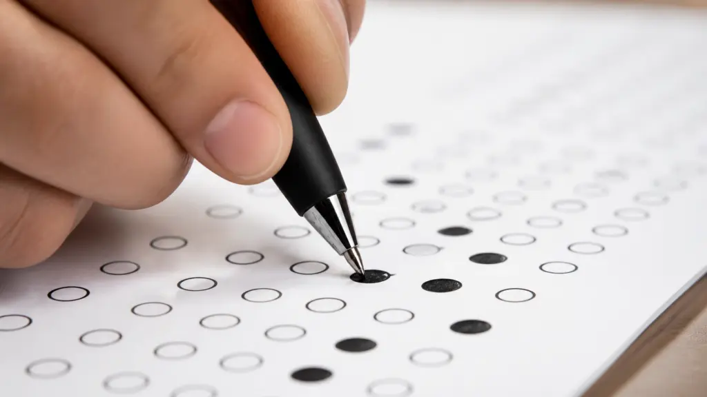 Close-up of a correctly darkened OMR answer bubble being filled with a ballpoint pen