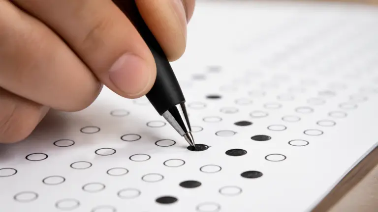 Close-up of a correctly darkened OMR answer bubble being filled with a ballpoint pen